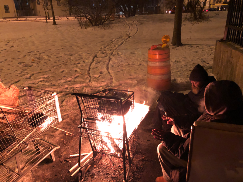 Some homeless people in Chicago attempting to stay warm.